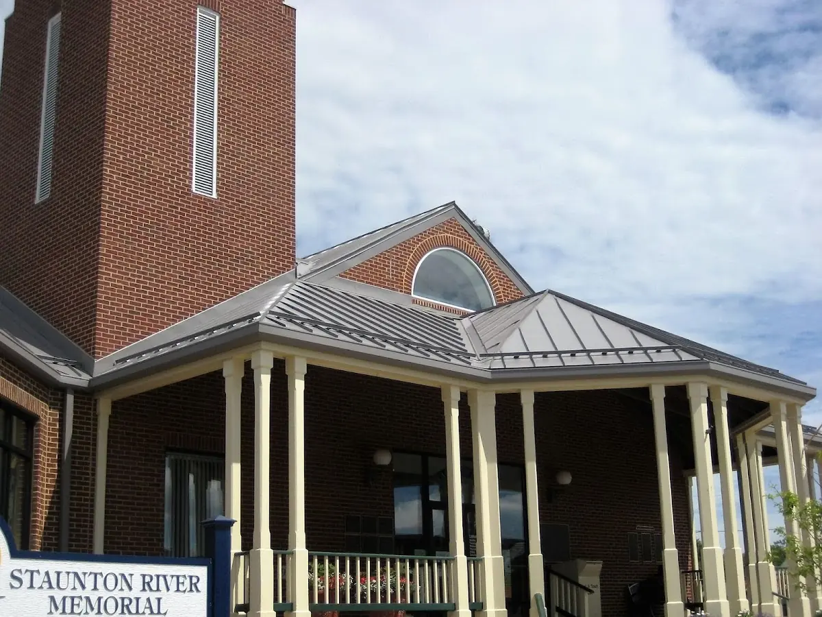 Skilled roofing craftsmen working on a residential roof in Winchester Center